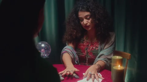 Female Seer Using Rune Stones while Talking to Her Client Stock Footage 253181735