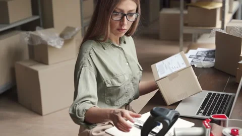 Female seller checking ecommerce parcel dropshipping orders using laptop. 스톡 동영상 141396704