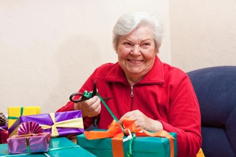 Female senior pack or unpack an gift 스톡 사진