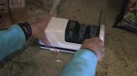 Female sharpening a knife Stock Footage 45618451