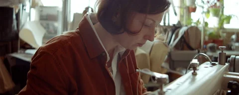 Female Shoemaker Using Sewing Machine at Work Video stock 165279246