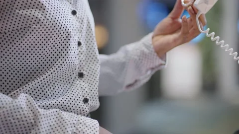 Female shopper is testing smartwatch in electronics shop, holding new model in Stock Footage 153132285