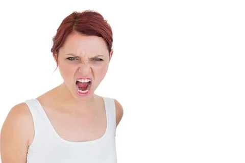 Female shouting toward camera in studio portrait wearing white tank top, copy Stock Photos