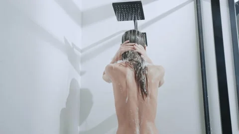 Female showering in bathroom Stock Footage 191941704