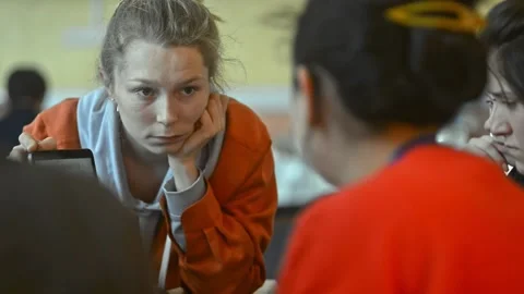 Female showing map design image in tablet to colleagues. irrl woman designer Stock Footage 136374656