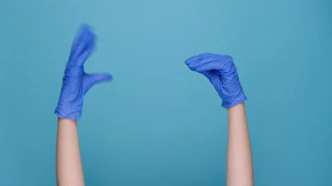 Female showing talking to each other hands, wears medical protective gloves Stock Footage 147436473