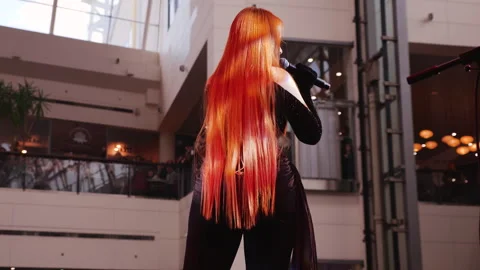 Female singer performs in a mall atrium.  Stock Footage 329142254