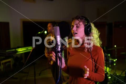Female Singer Recording In A Sound Studio