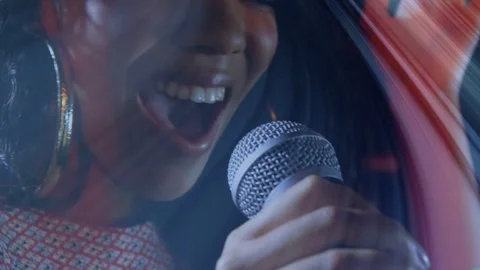 Female singer responding to raised crowd hand, belting into mic in music set Stock Footage 333818473