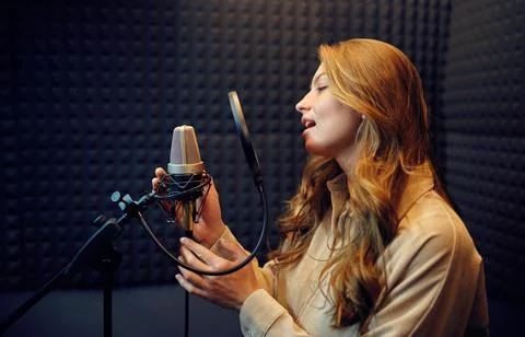 Female singer sings a song, recording studio Stock Photos