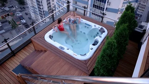 Female sit in a jacuzzi and talk with each other Video stock 80425651