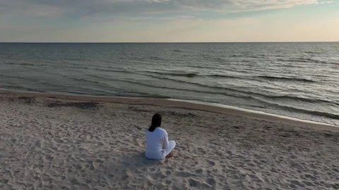 Female sitting on the beach Stock Footage 241449131