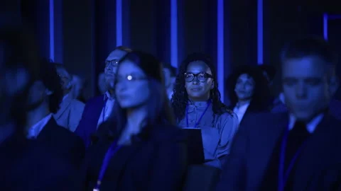 Female Sitting at Crowded Tech Conference with Laptop Video stock 223038700