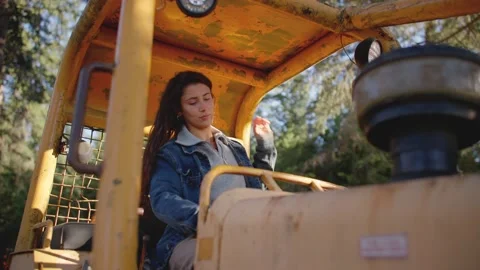 Female sitting down in tractor 库存影片 213487486