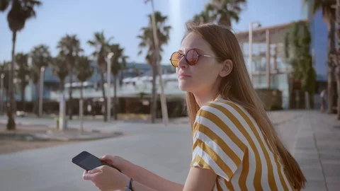 Female sitting with smartphone using online shopping app or social network Stock Footage 100302279
