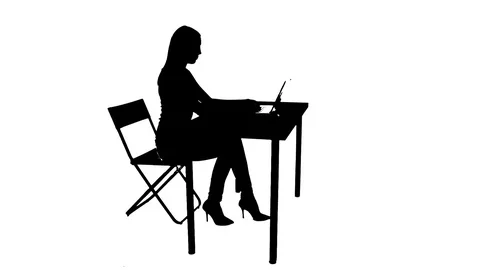 Female sitting at table and using laptop silhouette Stock Footage 81696743