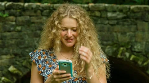 Female Smiles Texting 스톡 동영상 95079642