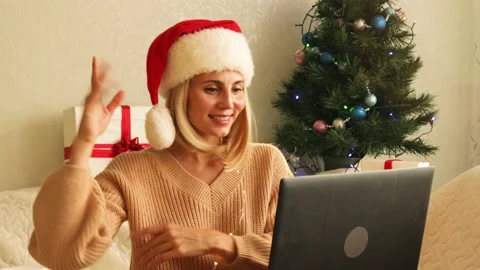 Female smiling, dancing, sitting on sofa in decorated living room. Christmas Stock Footage 164592092
