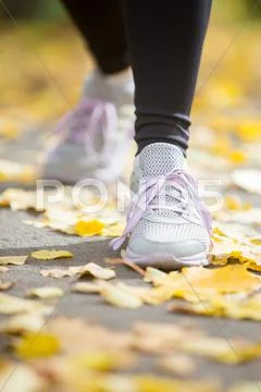 Female sneakers on the pave in a start position Stock Photos