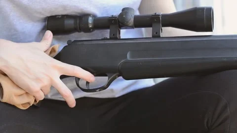 A female sniper cleans the optical sight of her rifle Stock Footage 195953983