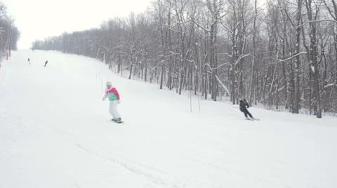 Female snowboarder slides in mountain winter day 스톡 동영상 59711931