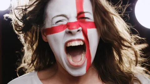Female soccer fan with England flag on the face screaming into a camera Stock Footage