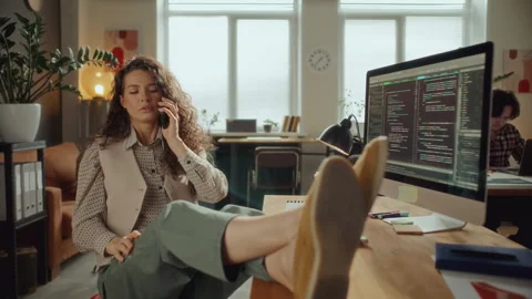 Female Software Developer Chatting on Cell Phone at Office Desk Stock Footage 305318038