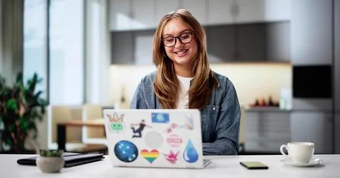 Female Software Developer Leading Virtual Conference Call From Kitchen Laptop 写真素材