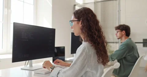 Female Software Developer Programming Code at Computer in Bright Modern Office Stock Footage 345880379