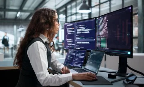Female Software Developer Remotely Coding Secure Web Applications Online. Stock Photos
