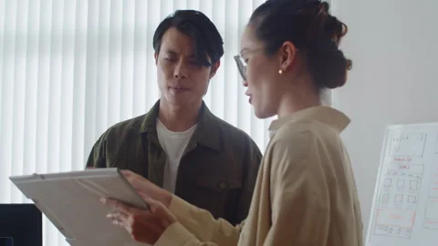 Female Software Developer Showing Document to CEO Discussing Plan of Work Stock Footage 256977433