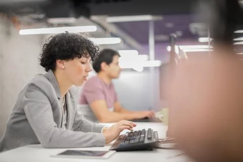 Female software developer using desktop computer Stock Photos