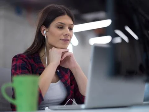 Female software developer using laptop computer Stock Photos