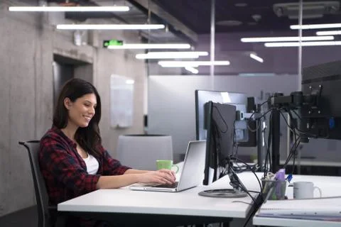 Female software developer using laptop computer Foto stock