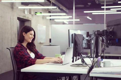 Female software developer using laptop computer Stock Photos
