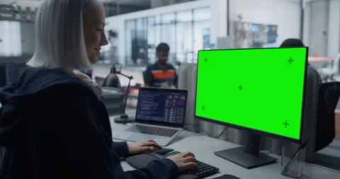Female Software Developer Working on Computer with Green Screen Stock Footage 296183520