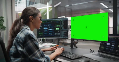 Female Software Developer Working on Computer with Green Screen Stock Footage 321012510