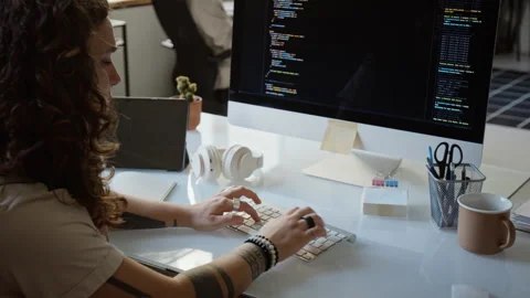 Female Software Developer Writing Code on Desktop Computer 库存影片 348145093