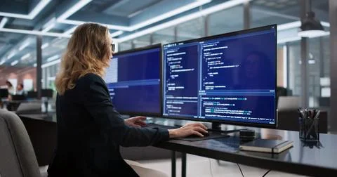 Female Software Engineer Developing Back-end Programs In Secure Office Enviro Stock Photos
