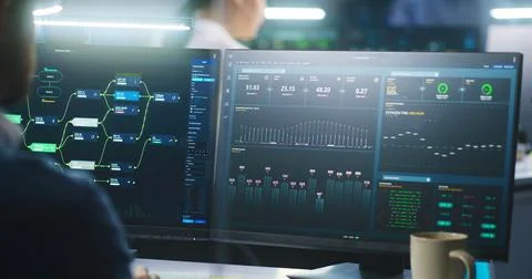Female software engineer works in modern monitoring control room 스톡 사진