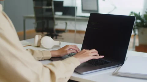 Female Software Engineer Writing Code Using Laptop at Office Stock Footage 256976470