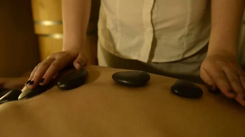 Female Spa Client Receiving Hot Stone Therapy 動画素材 75376909