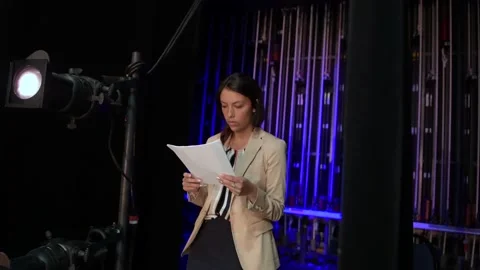 Female speaker practicing, reviewing notes backstage Stock Footage 220366029