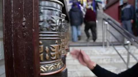 Female spinning prayerwheels Stock Footage 65775682