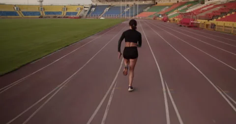 Female sprinter running fast on track Stock Footage 243625157