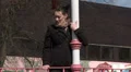 Female standing in park waiting for someone HD Footage
