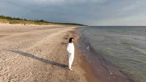 Female stands on the beach Stock Footage 241449128