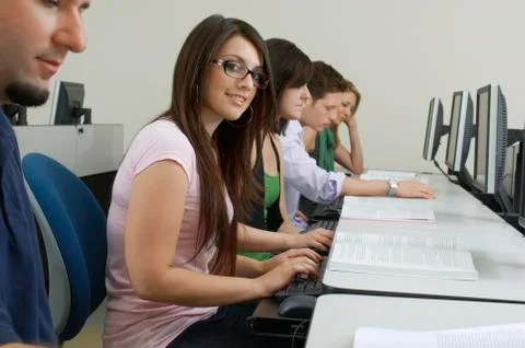 Female Student With Classmates In Computer Lab Stock Photos