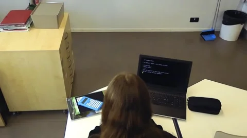 Female student coding on a laptop in a modern classroom Stock-Footage 344859812
