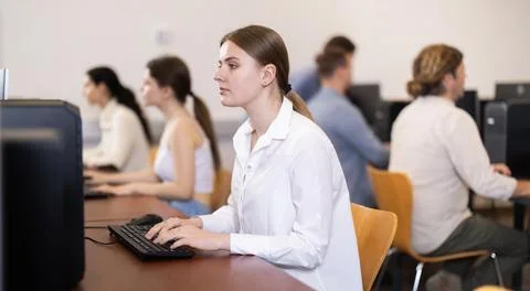 Female student at computers in university computer class Stock Photos